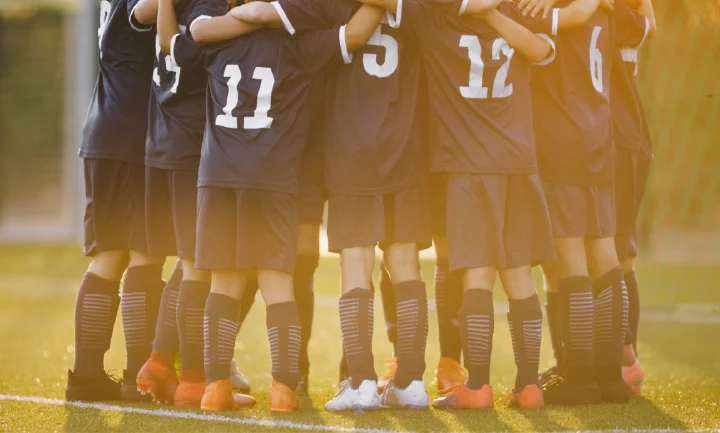 Soccer Team in a Huddle